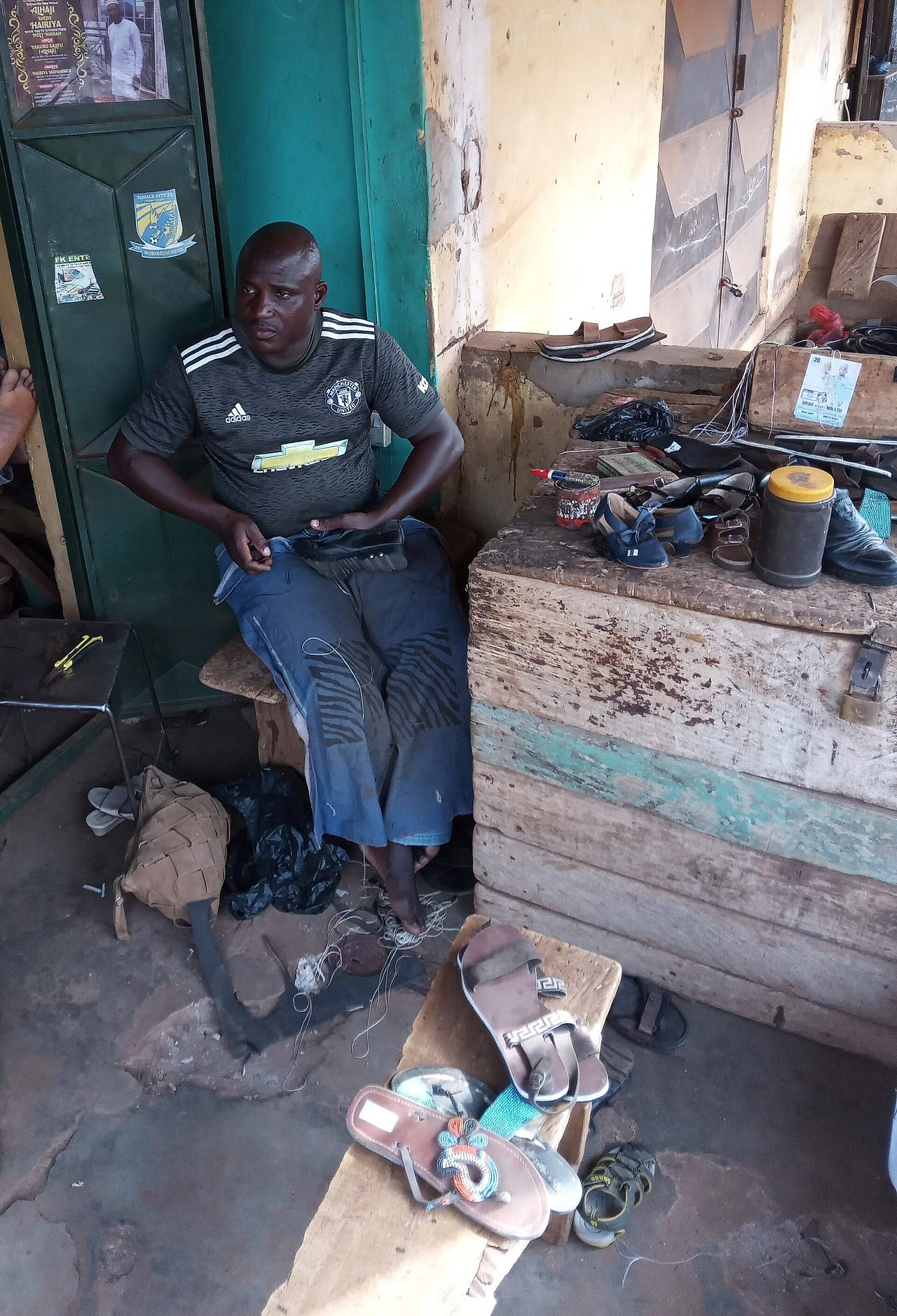 A Cobbler Sewing Shoe In His Shop