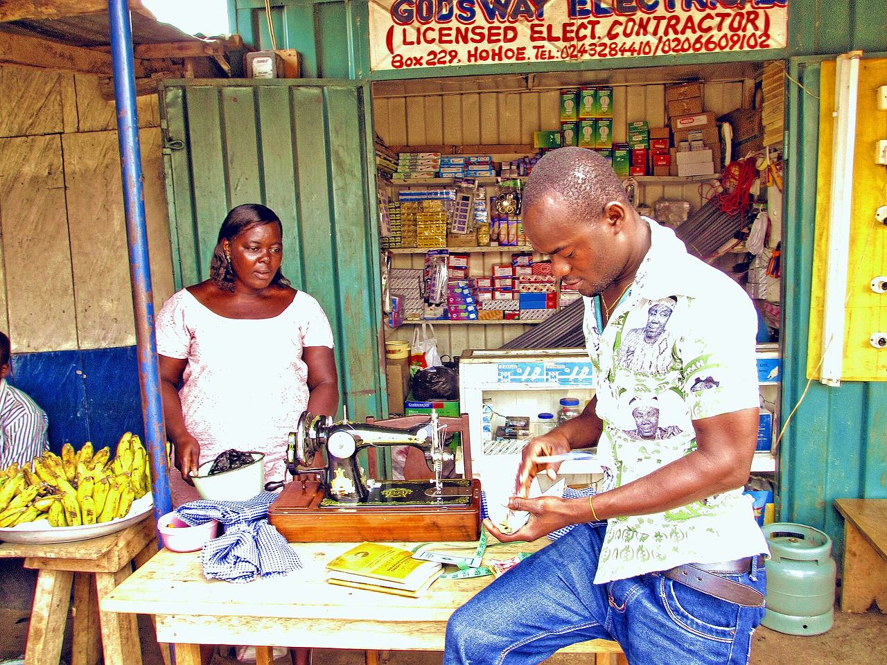 Microfinance collector at a kiosk in Hohoe (Volta Region, Ghana) Original caption: "Eric collecting money for E.P.D.R.A Micro Finance"