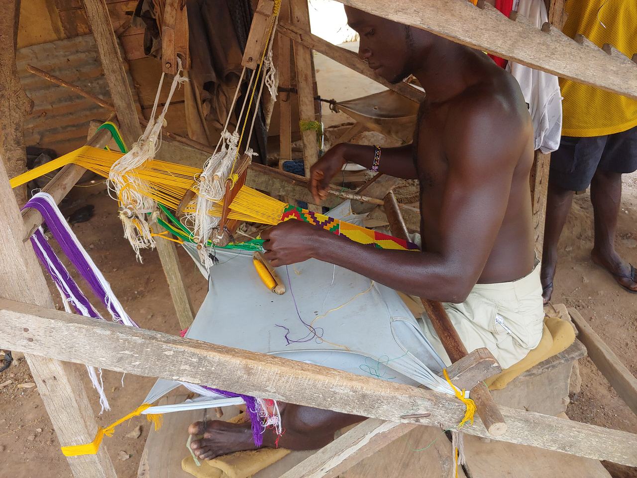 Man doing traditional Kente cloth weaving
