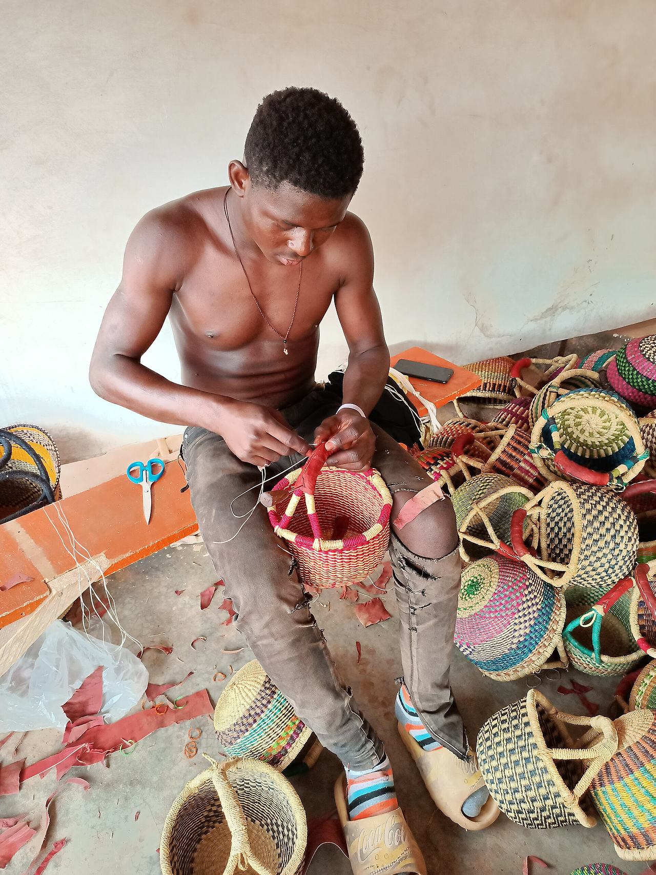 A man weaving basket in upper east region of Ghana