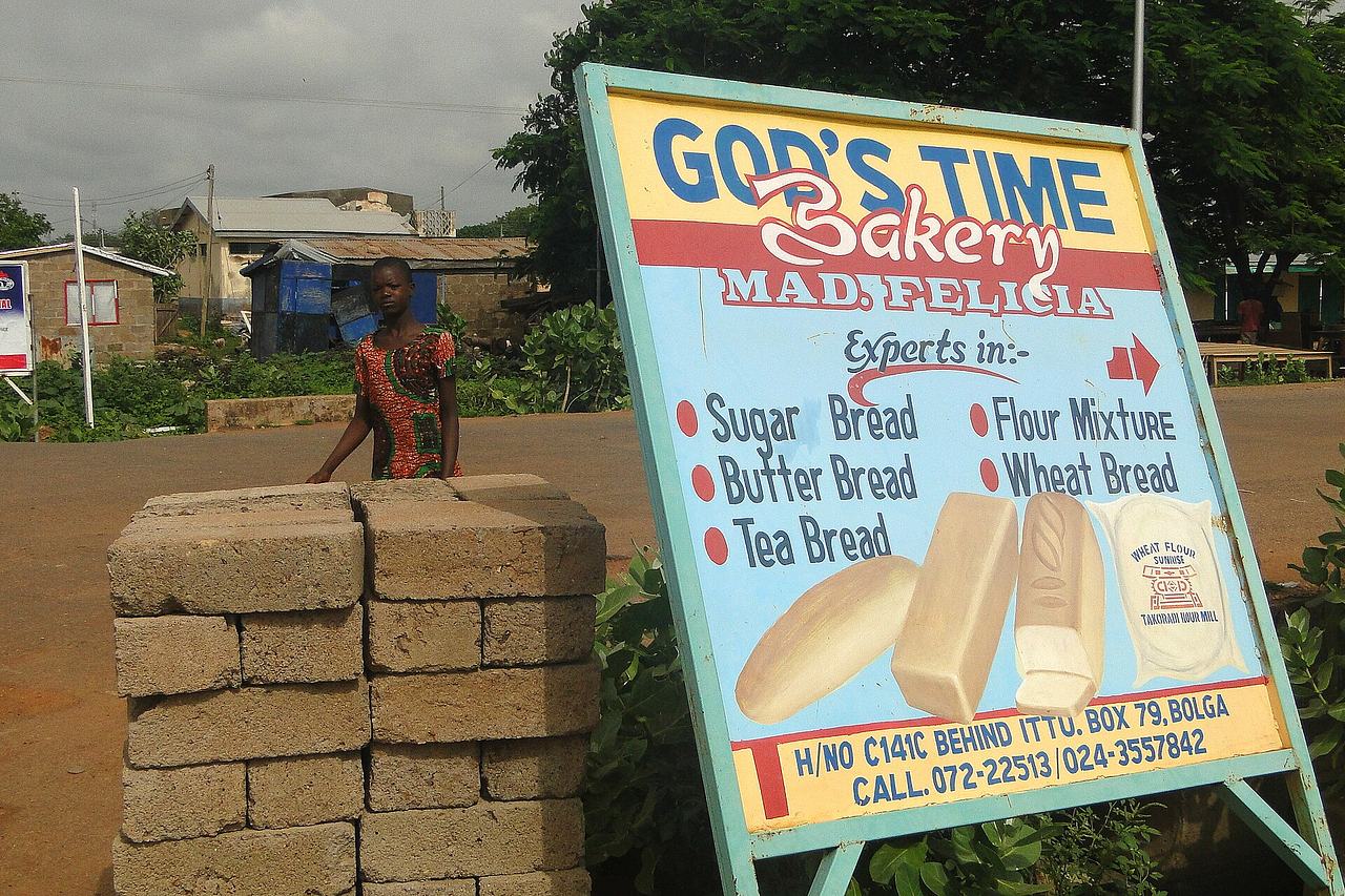 God's Time Bakery - Street Sign with Passerby - Bolgatanga - Ghana