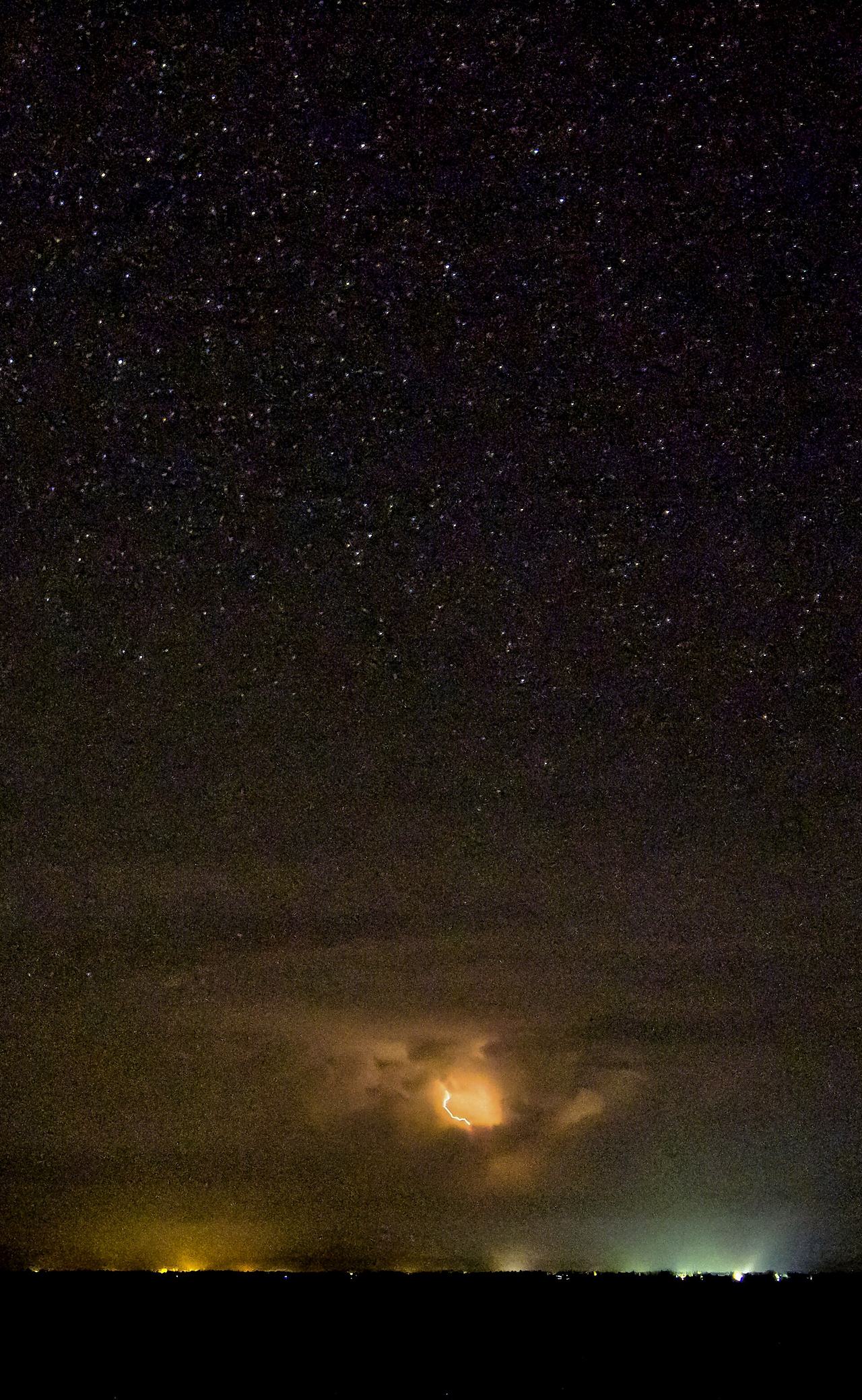 Stars and thunderstorm over the Awuna- (or Keta-) Lagoon (Anloga area; coastal hinterland in southeastern Ghana) Original caption: "Lagoon Storms 0 - For some reason most thunderstorms stop just on the north side of the lagoon, leaving our skies c...
