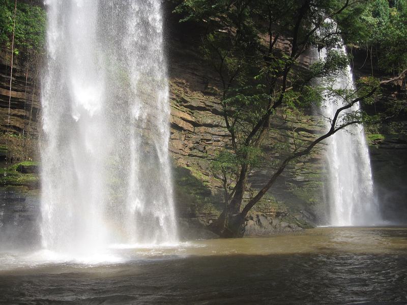 Twin waterfalls at Boti Falls descending into a rocky ravine surrounded by forest