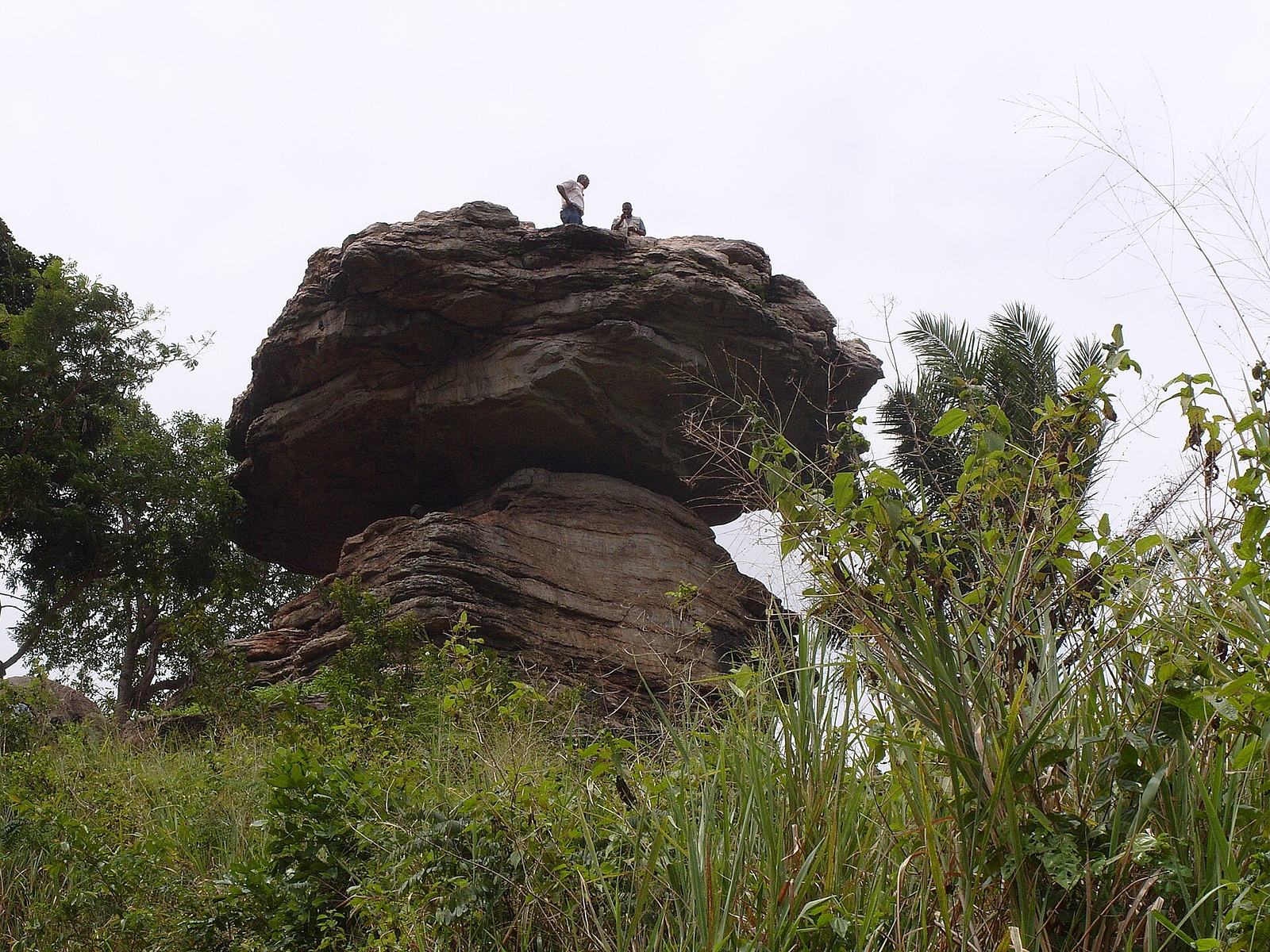 Umbrella Rock near Boti Falls, a broad rock overhang on a hillside