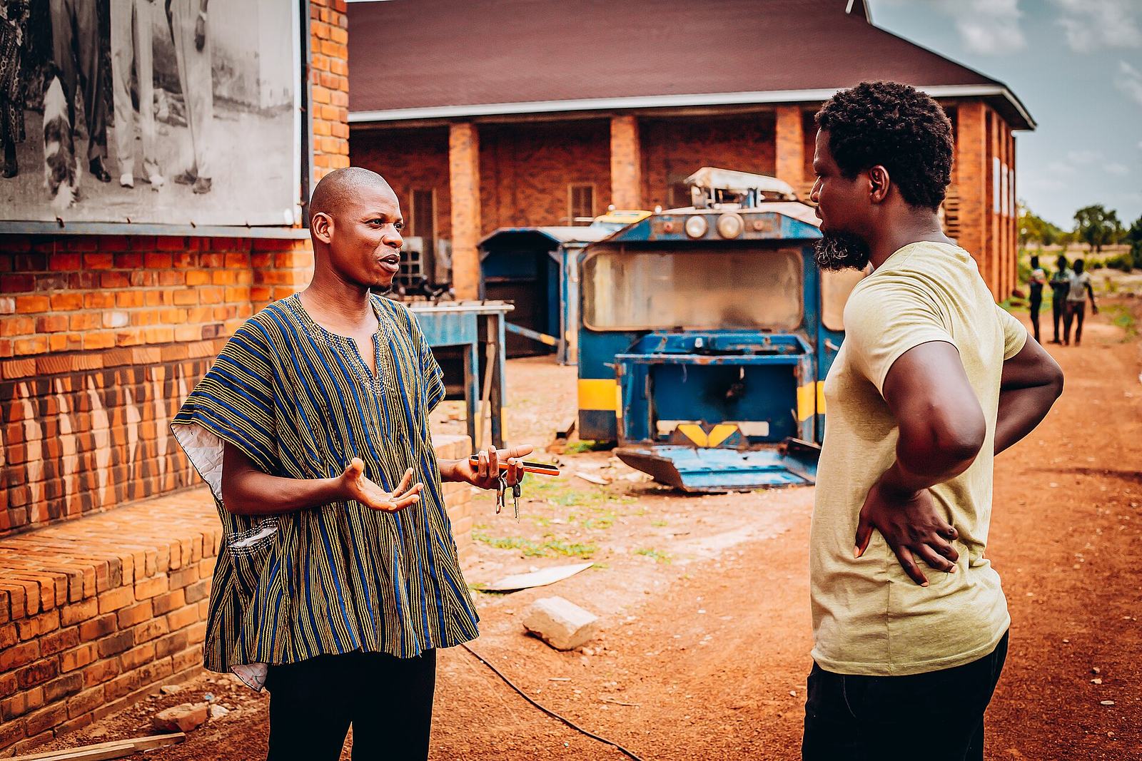 Mohammed Awal in standing discussion with the founder of Red Clay archival center, Ibrahim Mahama