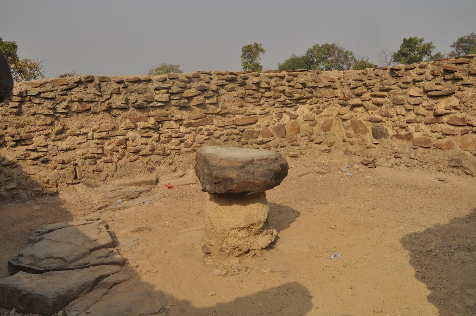 A rock enclosed by a low wall near Larabanga Mosque in northern Ghana.