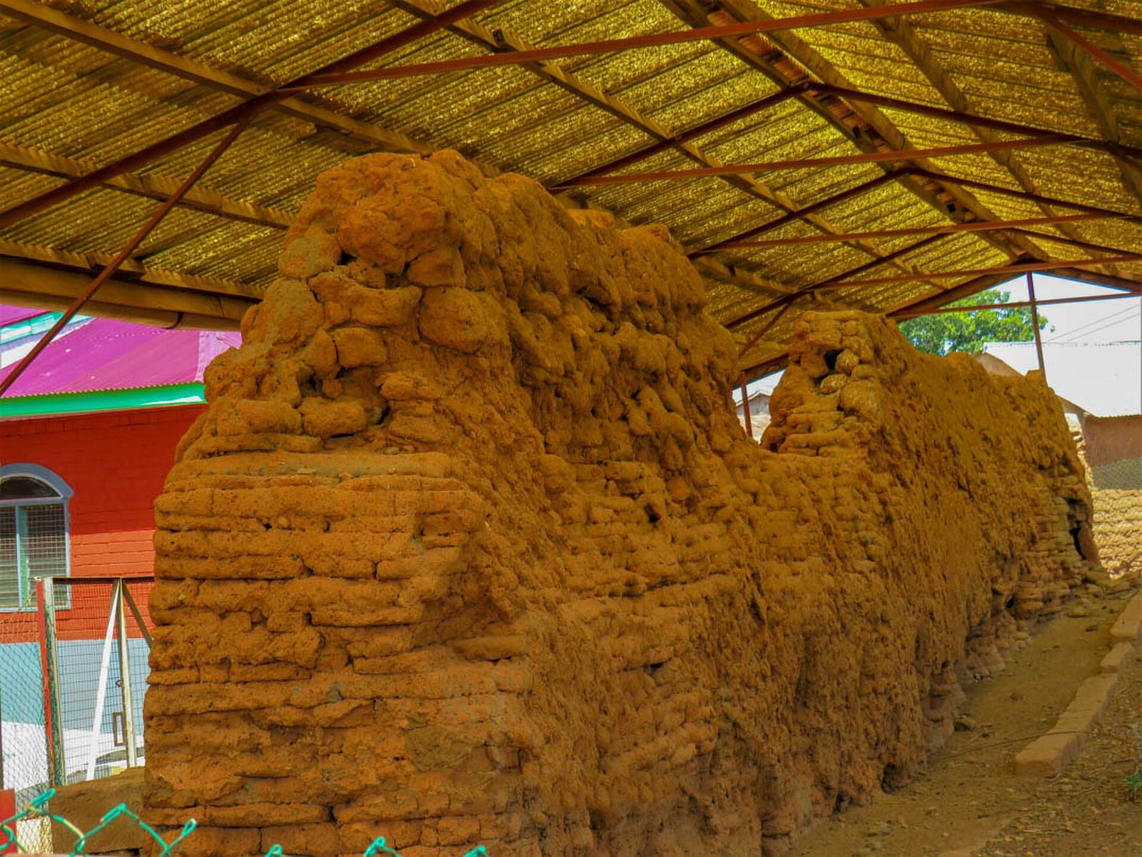 Mud defence wall remains at Gwollu, Ghana