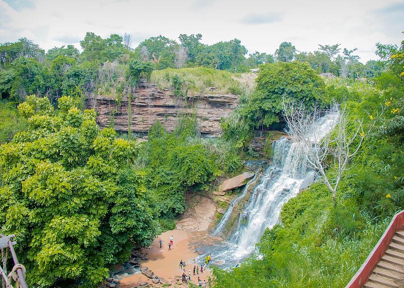 Elevated view of the multi-step cascades of Kintampo Waterfalls surrounded by forest