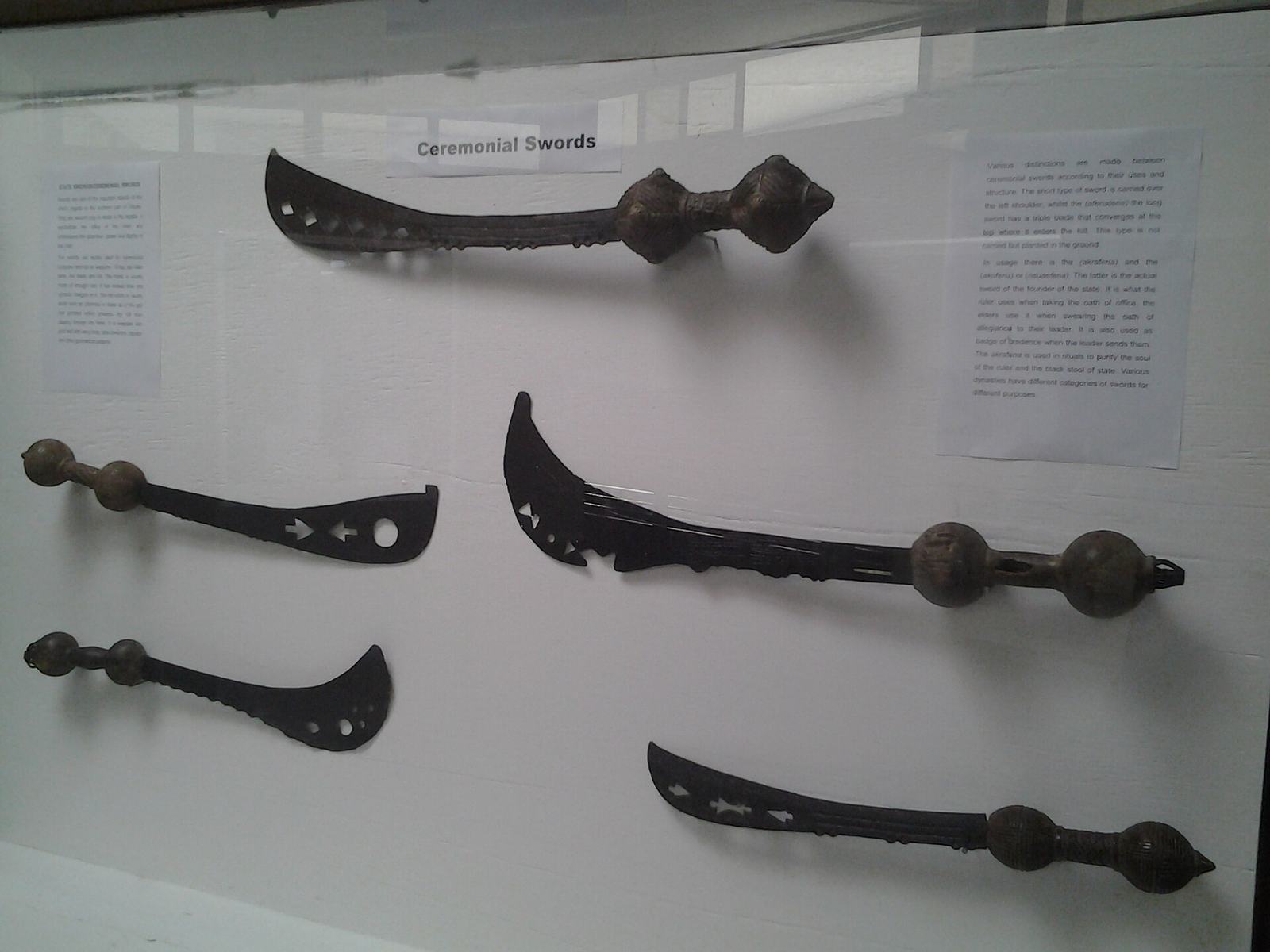 Display of pre-colonial royal machetes in a case at the National Museum of Ghana