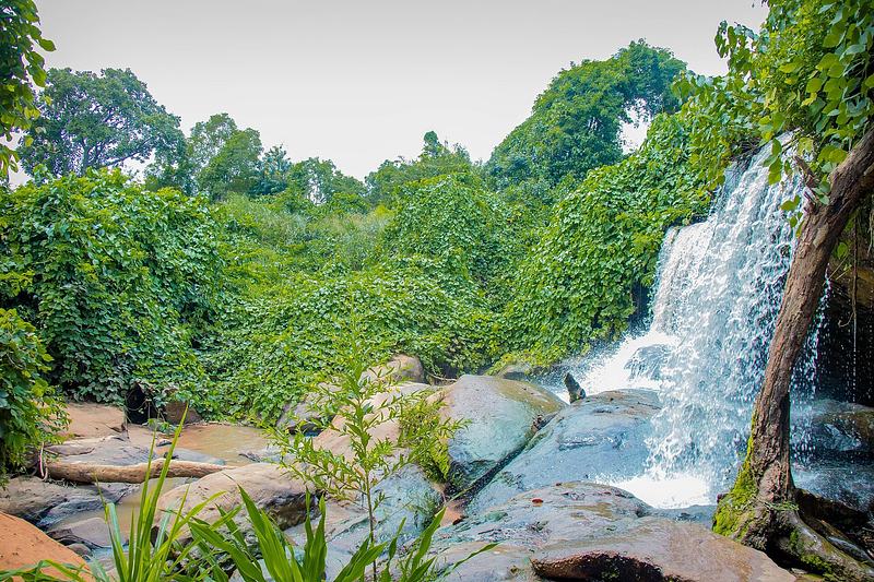 Water cascading over large rocks at Kintampo Waterfalls in the Bono East Region