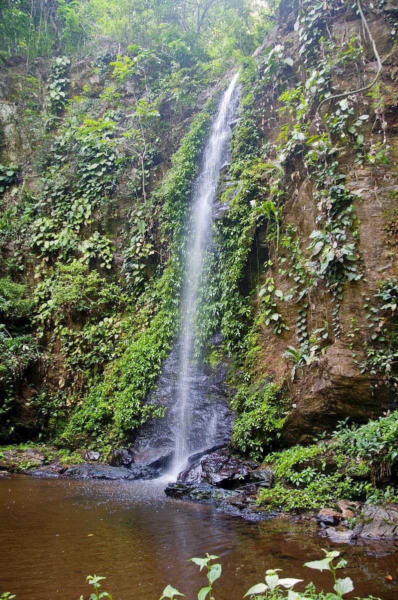 Water cascading over rocks at a small waterfall in Kyabobo National Park.