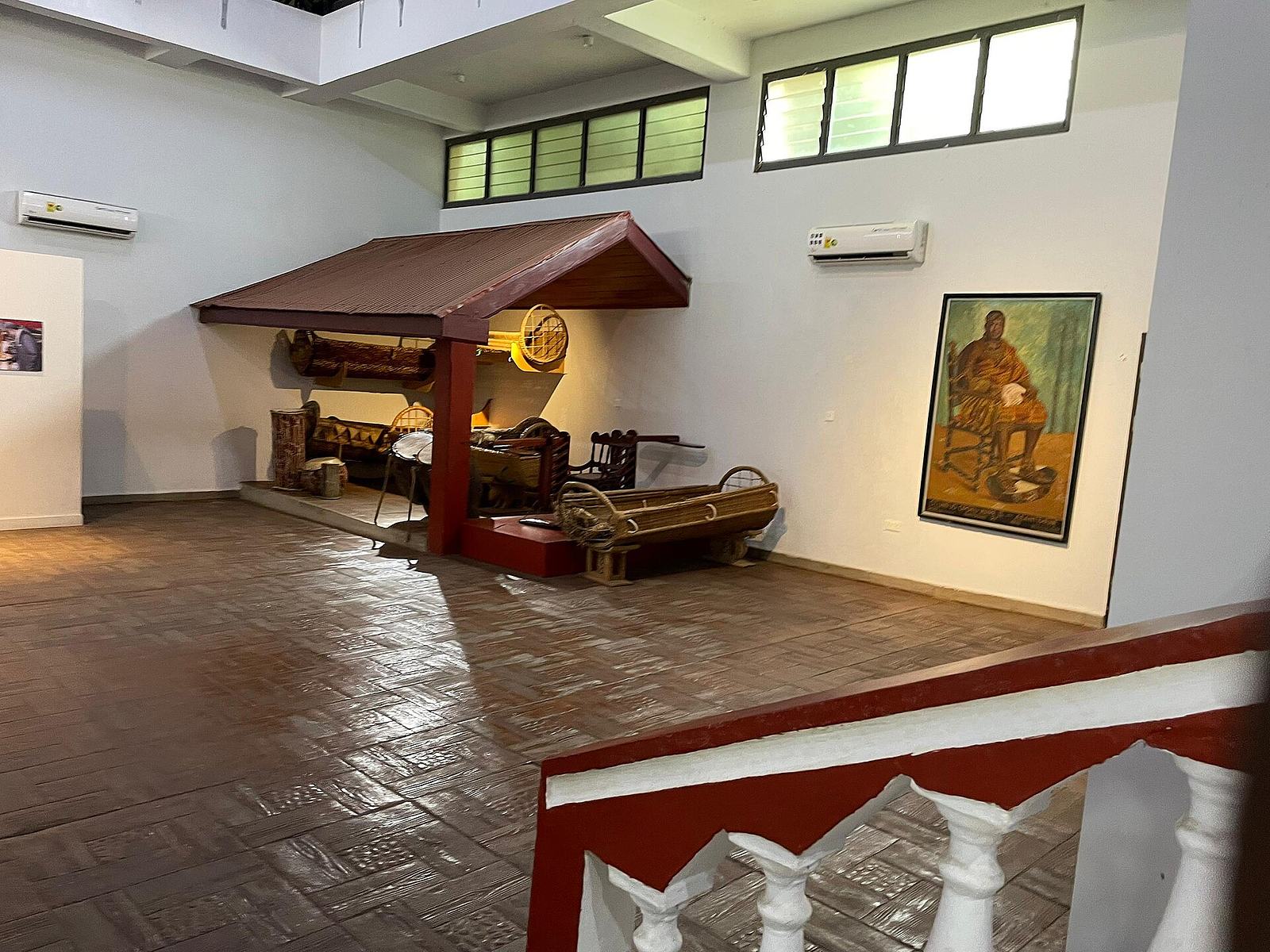 Museum exhibit recreating a traditional Ashanti royal setting with artifacts and furniture