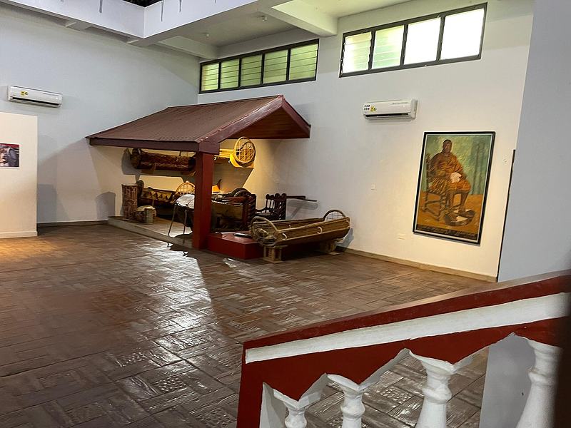 Museum exhibit recreating a traditional Ashanti royal setting with artifacts and furniture
