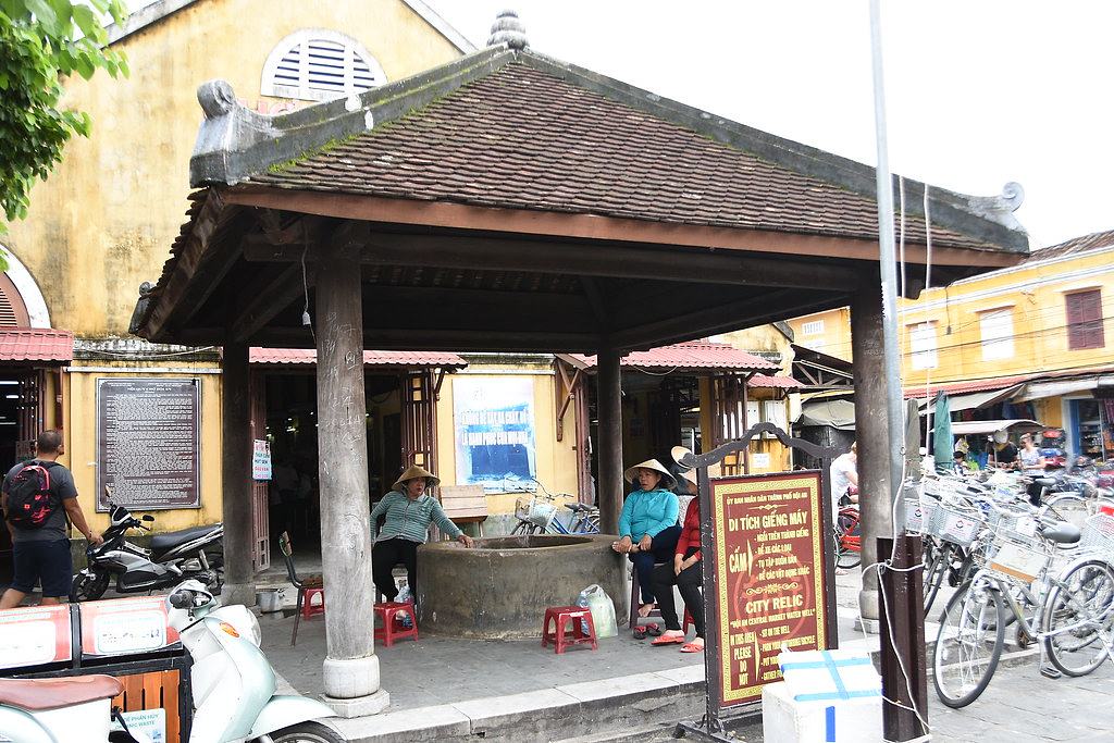 Vietnamese ladies chill out around a well at the Hoi An market