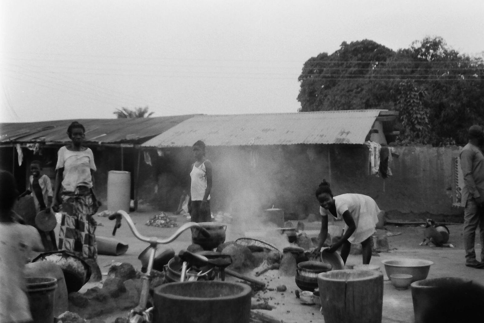 Black-and-white photograph of a lively outdoor rural scene in Kpandai, northern Ghana.